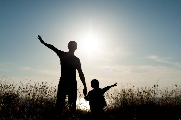 istock happy father and son on sea sunset background 816726564