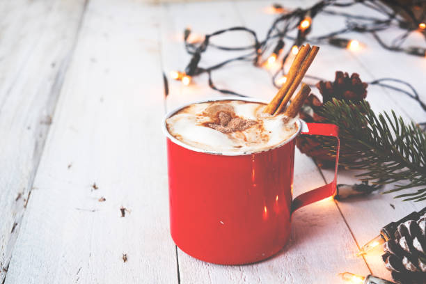 Cup of hot chocolate on wood table in Christmas Christmas background - Cup of hot chocolate on wood table with rustic decoration and Christmas lights. vintage color tone style. cinnamon photos stock pictures, royalty-free photos & images