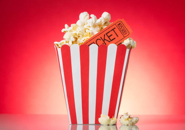 istock Large square box with popcorn and movie tickets on bright red . 816729148