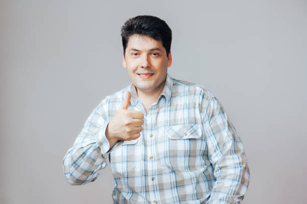 istock Happy man makes a gesture thumb up, portrait on white background 816736122