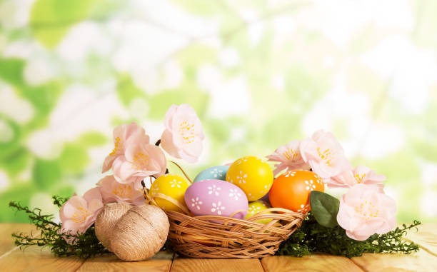 istock Are different Easter eggs in basket and near, grass, flowers . 816736360