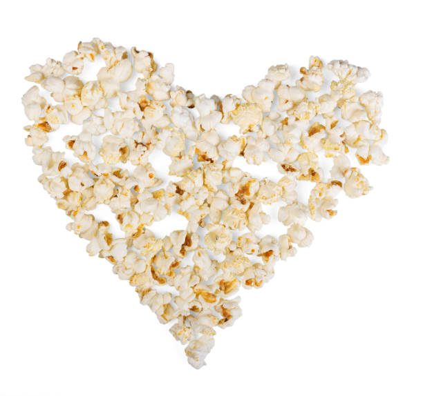 istock Popcorn, laid out in shape of heart on white background. 816743578