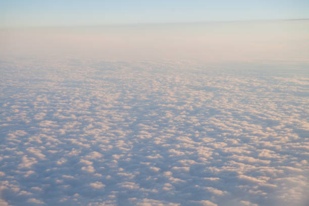 istock flying above the clouds at sunset landscape from an airplane 816758524