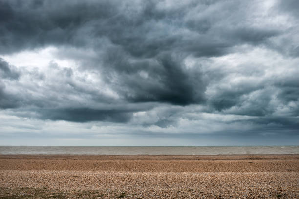 Storm clouds building over Winter beach landscape