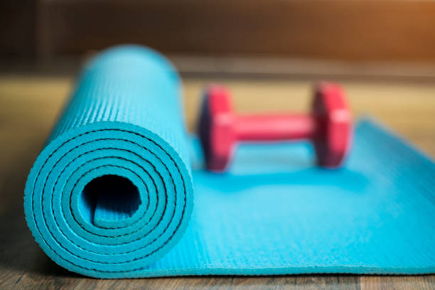 istock dumbbell and yoga mat on wood table 816758952