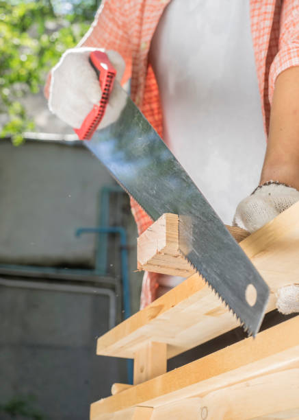 istock Carpenter holding a hand saw on the work bench 816763158