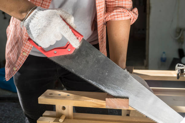 istock Carpenter holding a hand saw on the work bench 816765774