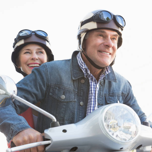 istock Happy senior couple riding a moped 816769766