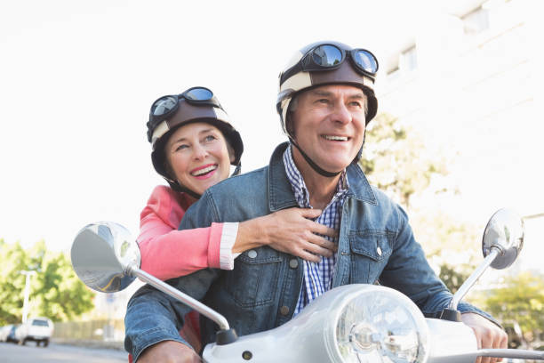 istock Happy senior couple riding a moped 816769880