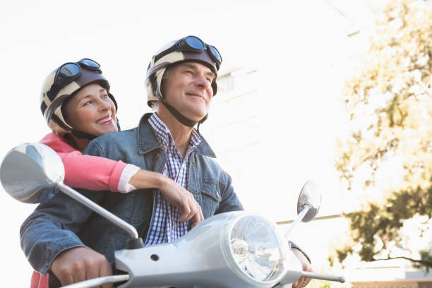 istock Happy senior couple riding a moped 816769914