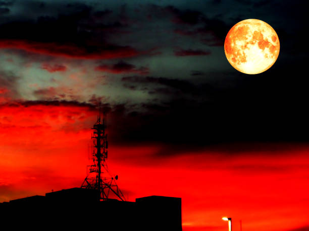istock super full blood moon and blur shadow signal pillar on roof 816774272