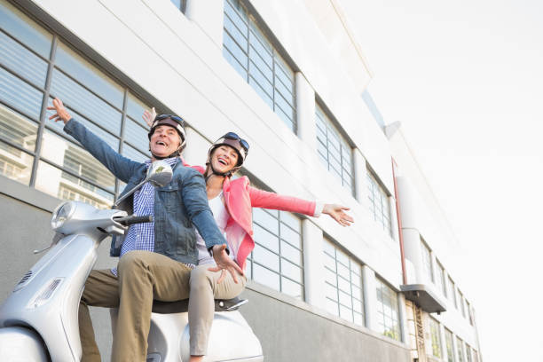 istock Happy senior couple riding a moped 816780288