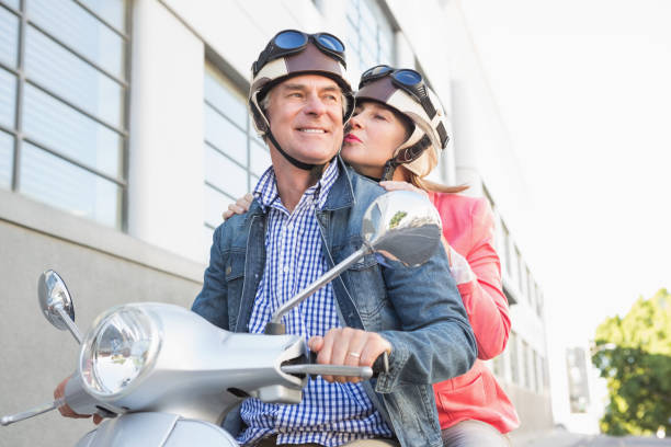 istock Happy senior couple riding a moped 816780332