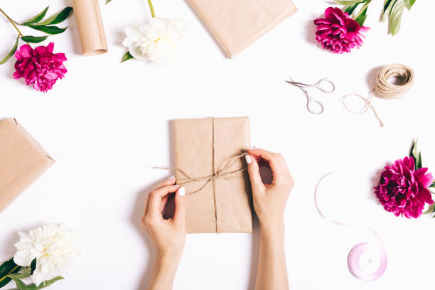 istock Women's hands pack gifts and make decorations for the holiday 816780346