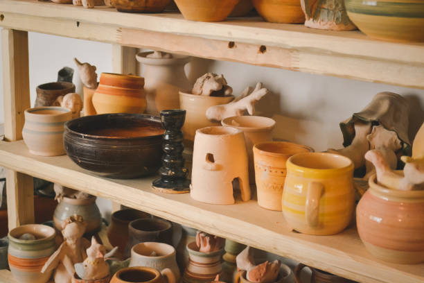 istock many different pottery standing on the shelves in a pottery workshop. Low light 816780990