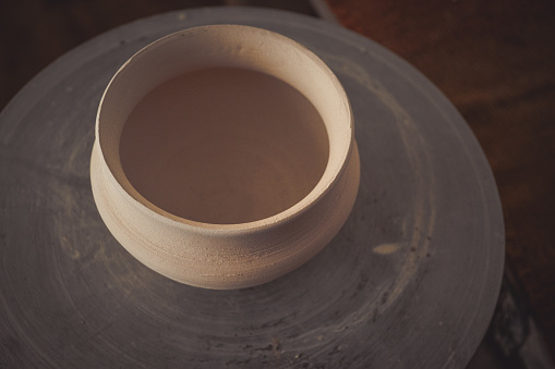 Clay pot on a potter's wheel close-up. Copy spase