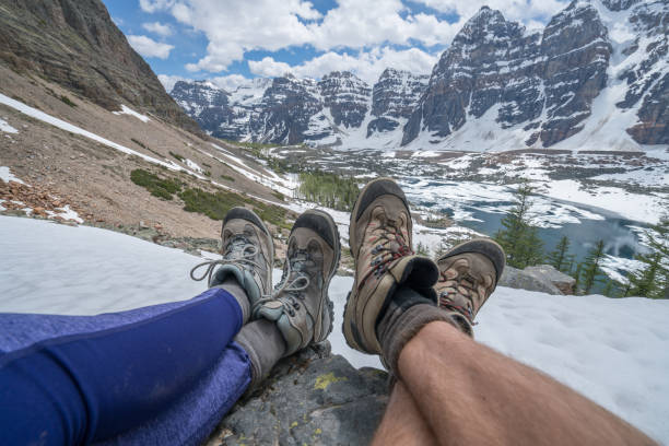 Personal perspective of couple of hikers resting on mountain trail