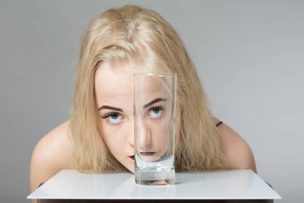 istock girl looks through glass 816798610