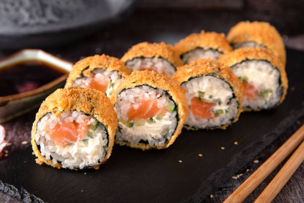istock Hot fried Sushi Roll with salmon, avocado and cheese. Sushi menu. 816801882