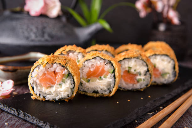 istock Hot fried Sushi Roll with salmon, avocado and cheese. Sushi menu. 816806730