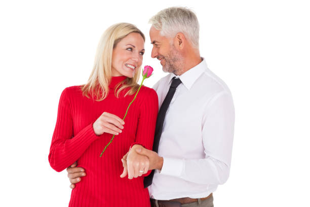 istock Handsome man giving his wife a pink rose 816807120
