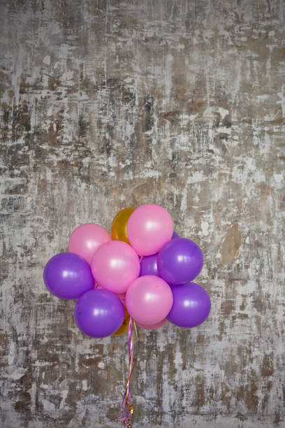 istock Bright balloons bunch against a textured wall 816816678