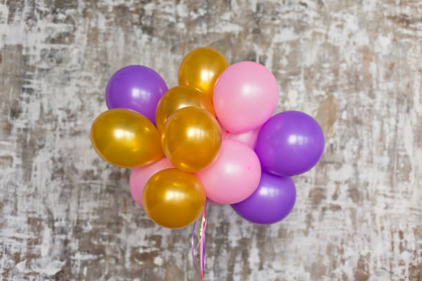 istock Bright balloons bunch against a textured wall 816822284
