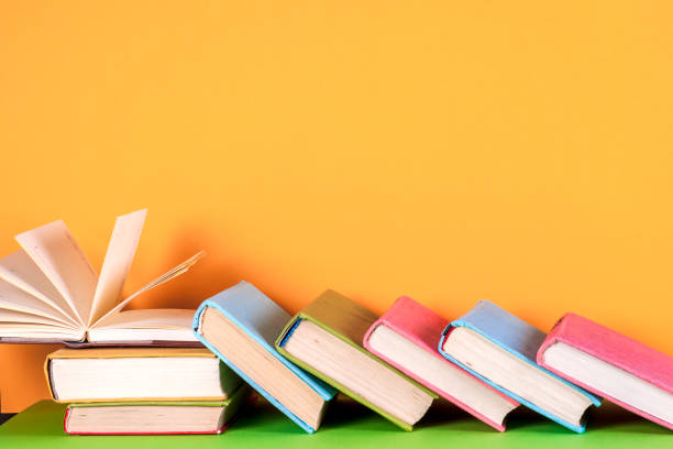 istock Open book, hardback books on bright colorful background. 816827128