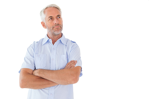 Thinking man posing with arms crossed on white background