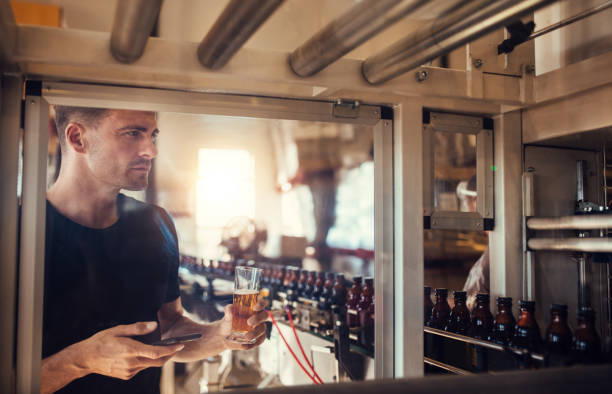 istock Young man examining beer at brewery 816835854