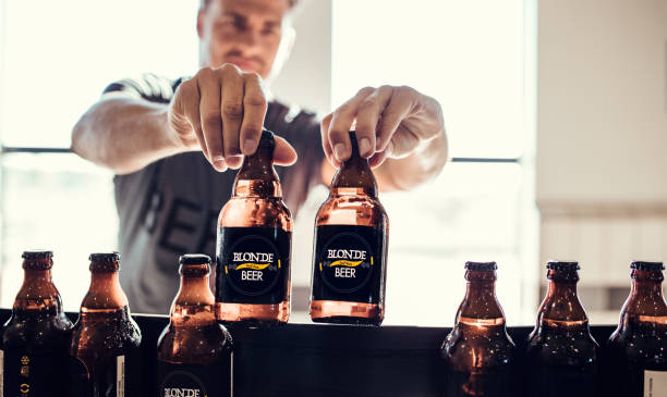 istock Young man inspecting the beer bottles on conveyor belt 816836146