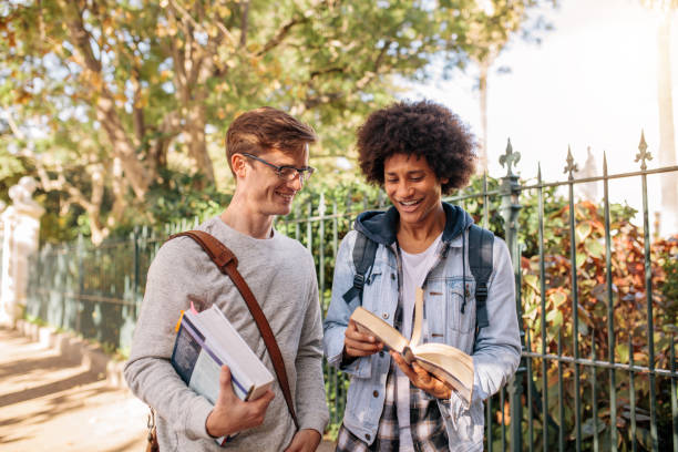 istock Students with books walking outside on the road 816838162