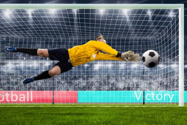 Photo of female goalie is jumping for the ball on crowded stadium