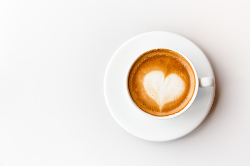 Top view of coffee latte on white background, heart shape