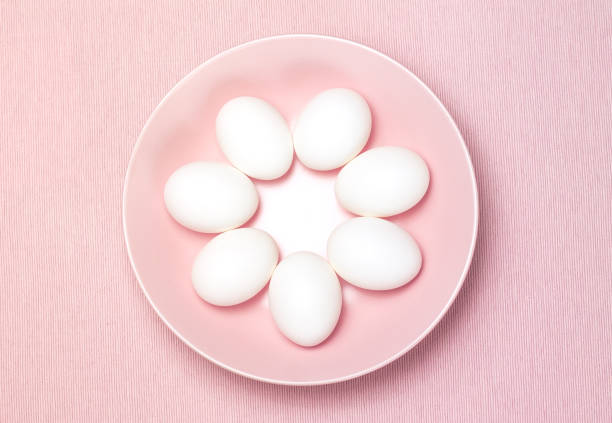 istock Top view of seven white egg on the pink plate and pink background 816846484