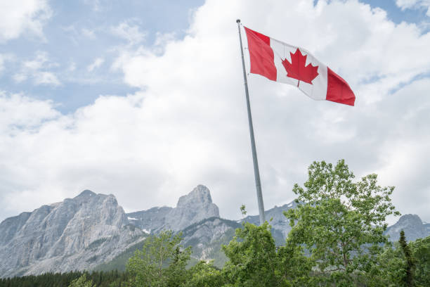 istock Canadian Flag Against Mountain Landscape 816846818
