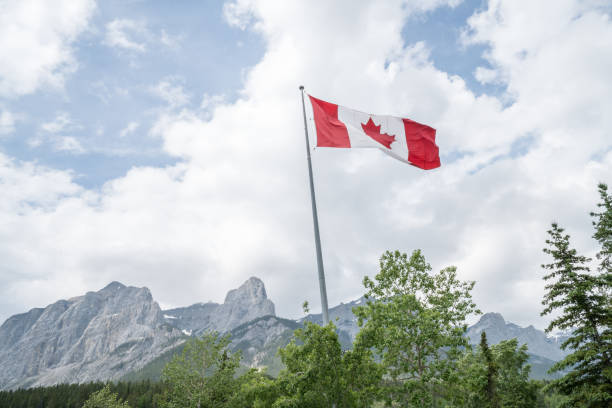 istock Canadian Flag Against Mountain Landscape 816846830