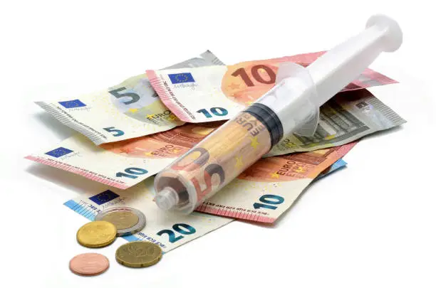 financial syringe on many euros white background