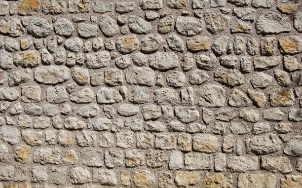 istock Wall made of the same type of stones 816852990