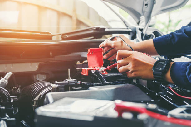 istock Auto mechanic checking car battery voltage 816860798