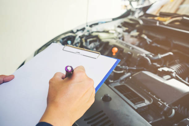 istock Mechanic man holding clipboard and check the car 816861156