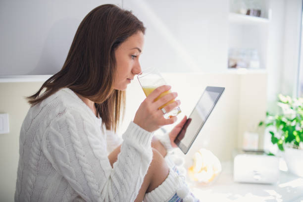 istock Woman drinking juice in kitchen 816868952