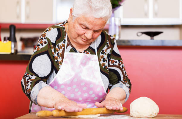 istock Woman kneading dough on kitchen counter 816871508