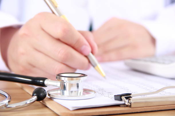 istock Female doctor writing on a clipboard 816881918