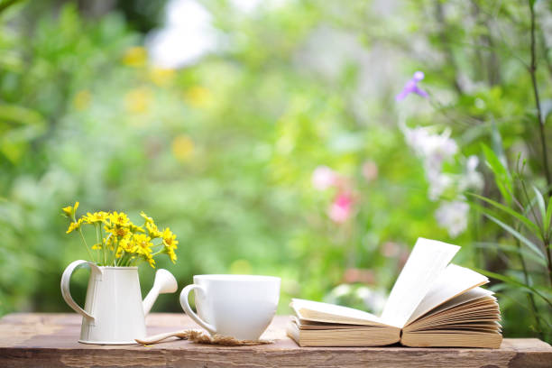 istock Notebook with Cryptostegia flower and cup on wooden table 816882388