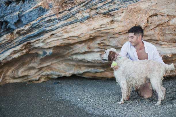 Man playing with his dog on the beach
