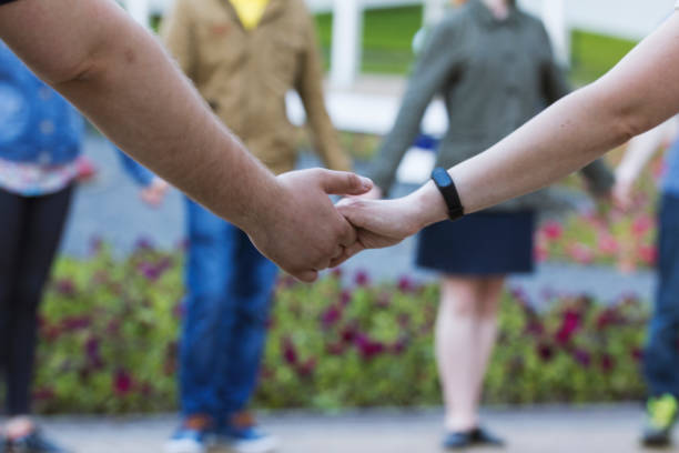 istock A lot of people holds hands in park - dancing performance 816892424
