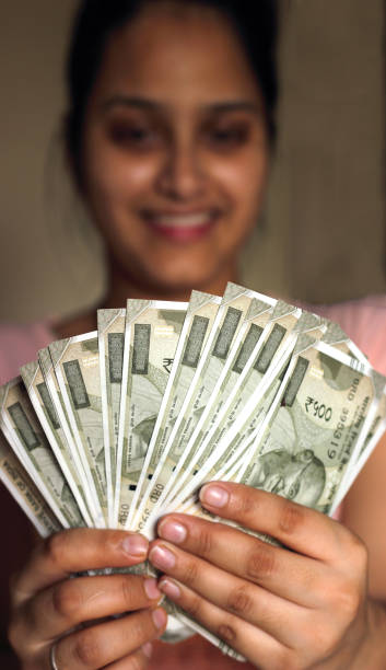 Young girl counting Indian Currency Notes stock photo