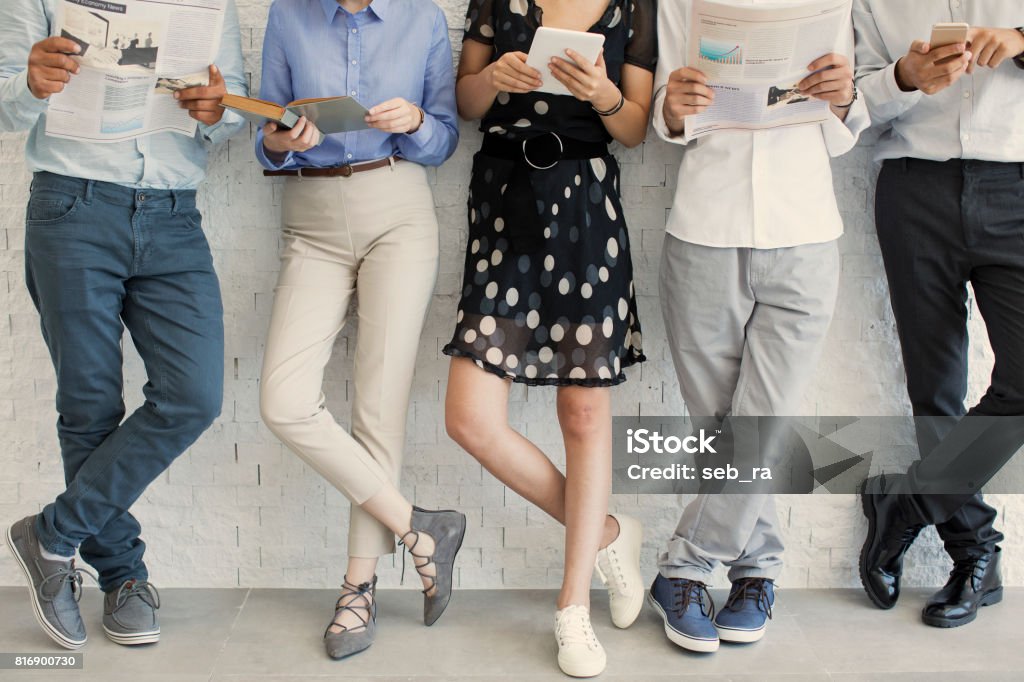 People using digital devices Newspaper Stock Photo