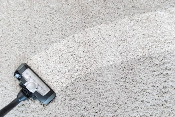 Photo of Cleaning carpet hoover.